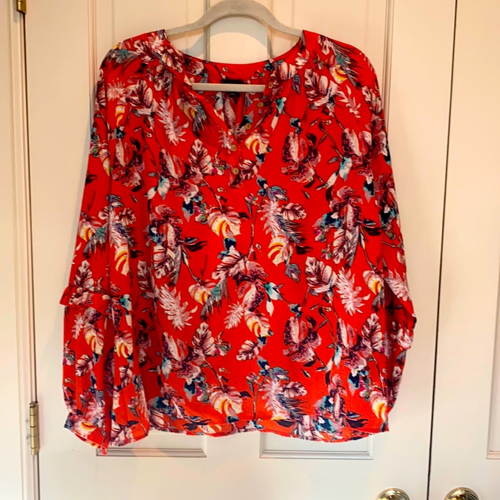 Adorable Blouse with ruffle detail on the sleeve.